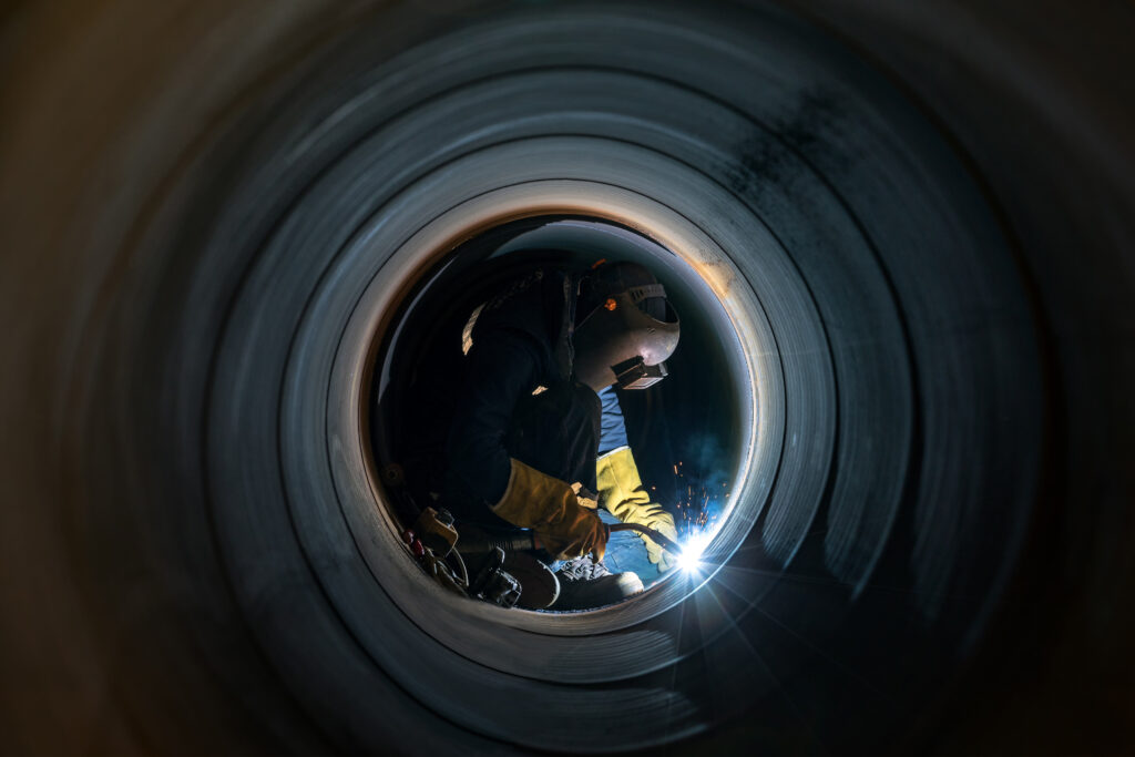Welder,Is,Welding,In,The,Spiral,Welded,Large,Pipe.,The Pipeline welding