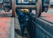 Rail,Maintenance,Technician,Use,Flashlight,To,Examine,Wheel,Assembly,Of