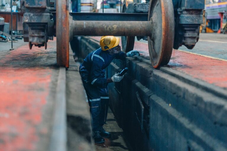 Rail,Maintenance,Technician,Use,Flashlight,To,Examine,Wheel,Assembly,Of Rail,Maintenance,Technician,Use,Flashlight,To,Examine,Wheel,Assembly,Of