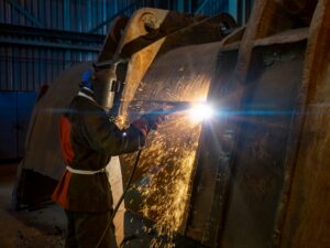 Heavy industry welding Welder working on large industrial metal equipment